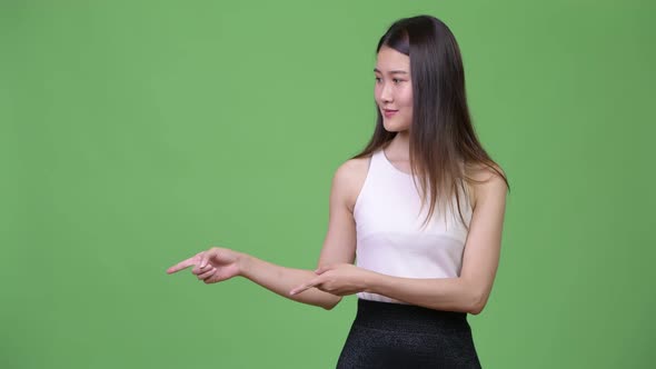 Young Beautiful Asian Businesswoman Showing Something