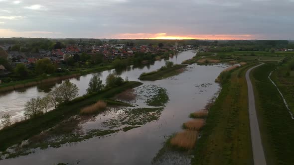 Panoramic aerial view of swamp and houses in background at sunset alt
