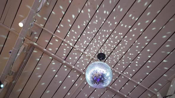 The Disco Ball Rotates and Reflects Beautiful Light