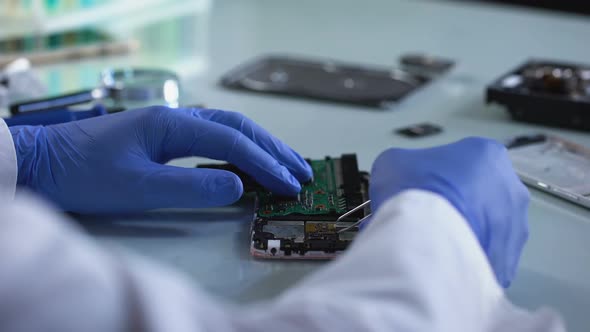 Lab Worker Analyzing Computer Part, Forensic Science Experiment, Information alt