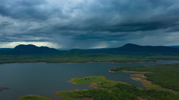 Rain storms and black clouds moving over the mountains. alt