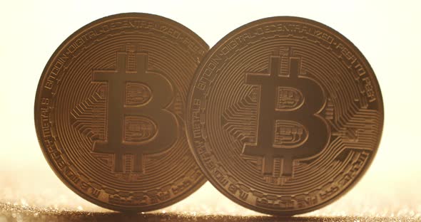 Close Up New Virtual Currency Bitcoin BTC Coin on Gold Background with Bokeh alt