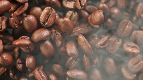 Super Slow Motion Detail Shot of Coffee Beans and Smoke Background at 1000Fps alt
