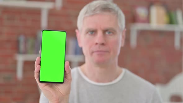 Senior Old Man Holding Smartphone with Chroma Screen alt