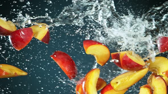 Super Slow Motion Shot of Flying Fresh Peach Slices and Water Side Splash at 1000Fps alt