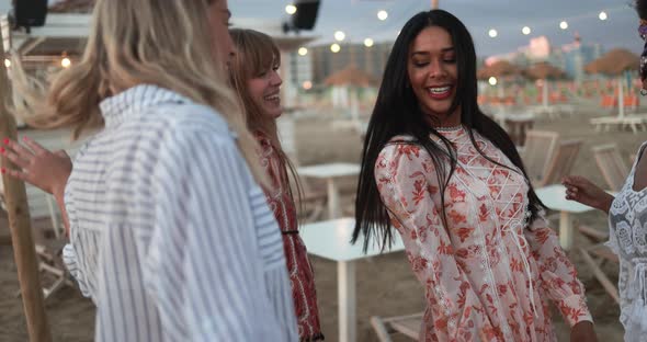 Multiracial female friends having fun dancing together outdoor at beach party alt