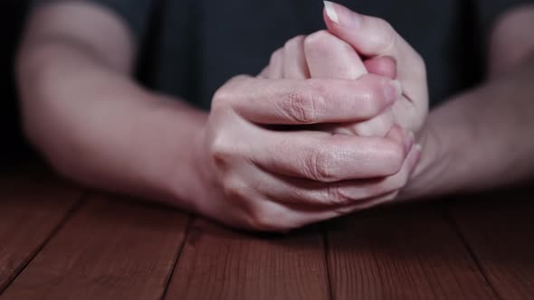 Woman with pain in her hand.  close-up woman holding her hand against dark background , Pain concept