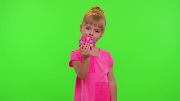 Girl Playing Spinning with Pop It Sensory Antistress Toy in Park Stress Anxiety Relief Chroma Key alt