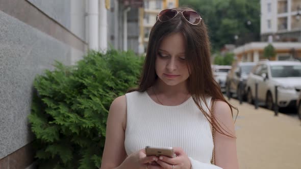 Smiling Girl with Freckles Use Smartphone