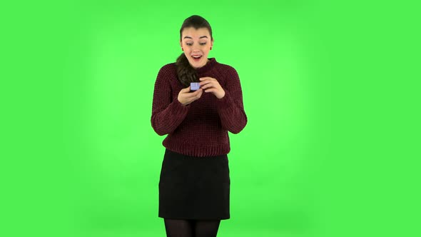 Girl Opens a Small Box with a Surprise and Is Very Disappointed with What She Saw. Green Screen alt