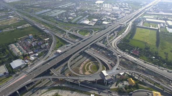 Aerial View of Highway Road Interchange with Busy Urban Traffic Speeding on Road alt