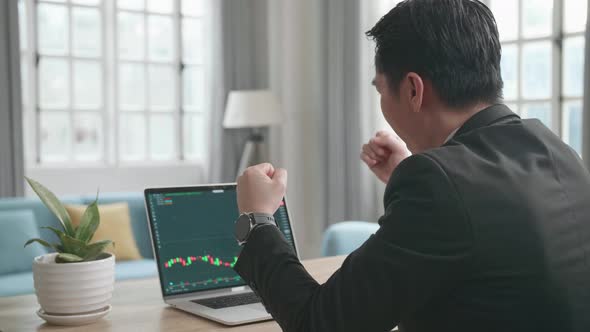 Businessman Being Happy After Seeing Uptrend In The Trading On Computer Screen While Work at Home alt
