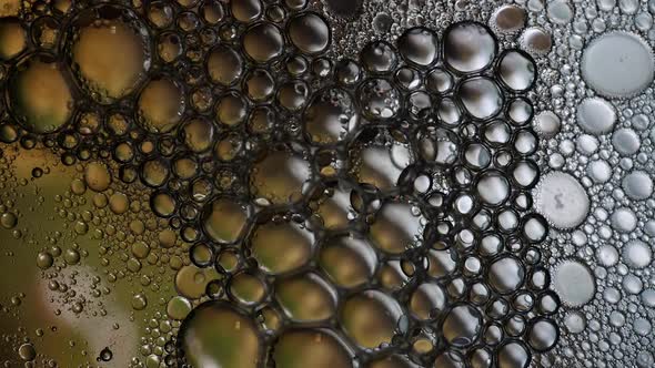 Bubbles popping in liquid mixture of water and oil alt