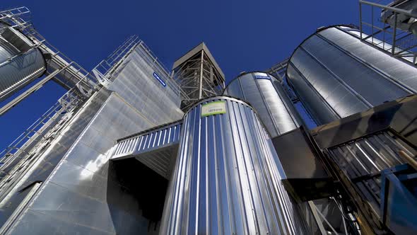 Metallic warehouse outdoors. Large aluminium containers against blue sky.  alt