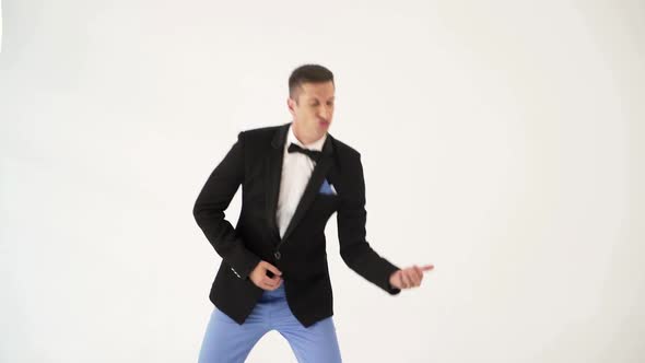 man in a black jacket is behaving like a guitar player at a concert of his rock band. alt