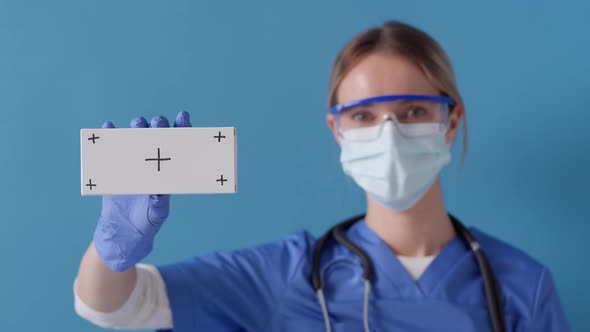 Nurse showing white box for medicine with tracking markers. Healthcare concept