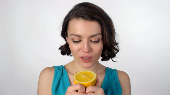 Young Woman Enjoying Tasty Orange alt