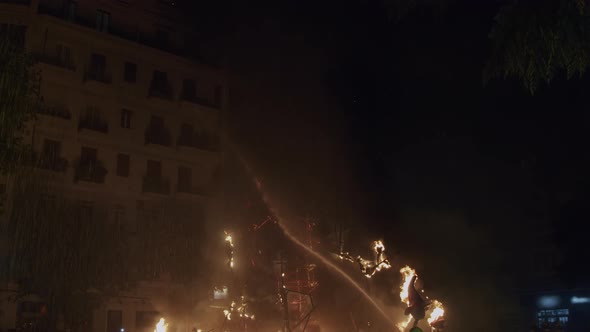 A Team of Firemans Extinguishes Festive Bonfires