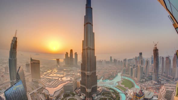 Paniramic Skyline View of Dubai Downtown During Sunrise with Mall Fountains and Burj Khalifa Aerial alt