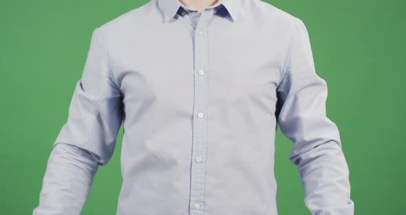 Punching his fist into his hand alt