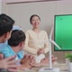 Asian Woman Engineer With Solar Cell Presenting About The Green Screen Tv At The Office - VideoHive Item for Sale