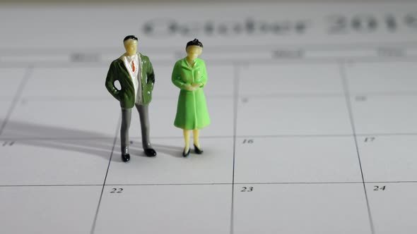 Couple Figurines on a Calendar. 