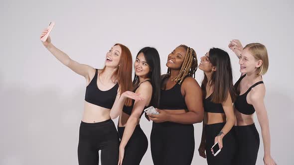 Portrait of Beautiful African Caucasian and Asian Women Taking Photo on Smartphone's Camera alt