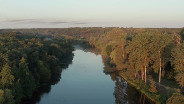 Beautiful morning, summer flight over the river. Fog, trees. alt
