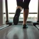 Bottomup Vertical Panorama of a Beautiful Girl Running on a Treadmill