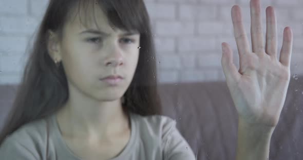 Girl Behind Window in Loneliness alt