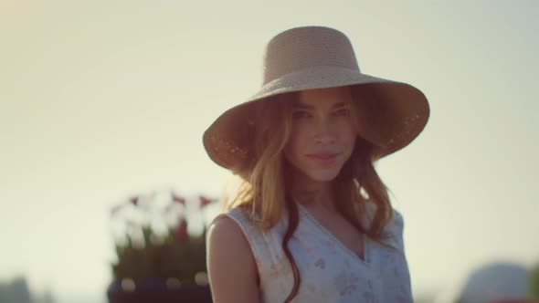 Sensual Blonde Woman in Sunhat Looking at Camera in Bright Summer Day Outside alt