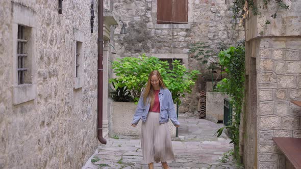 A Young Woman Visits the Old Town of Kotor in Montenegro alt