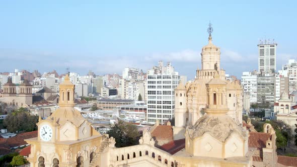 Cathedral in front of Córdoba skyline in Argentina, sinking aerial alt