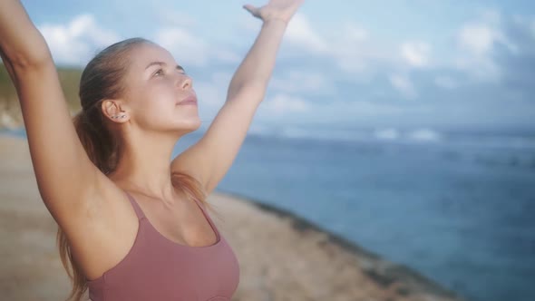 Portrait of Woman Practices Yoga, Concentrates on Breathing at Beach, Slow Motion alt