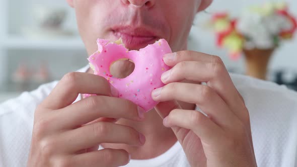 Man Biting an Appetizing Donut alt