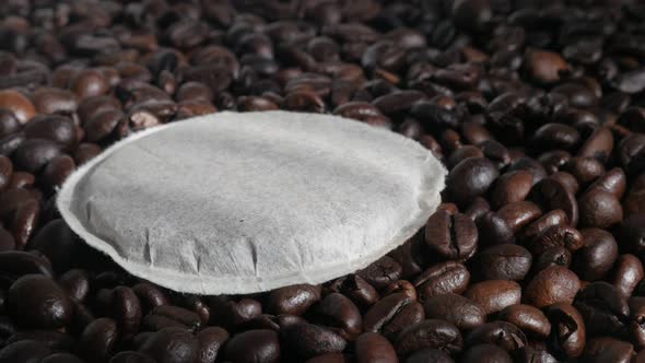 Tilting over filter coffee pods and  roasted beans 4K video alt