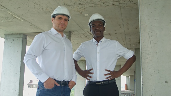 Architectural team smiling at the camera with hard hats