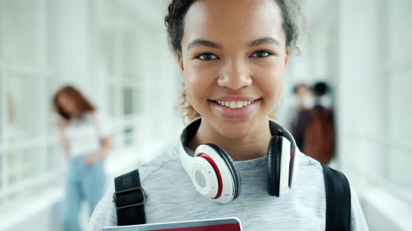 Close-up Portrait of African American Lady Student Smiling in University Hall alt