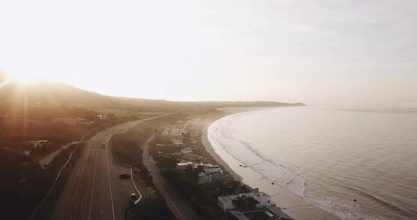 Aerial View Over Coastline Road During Sunrise