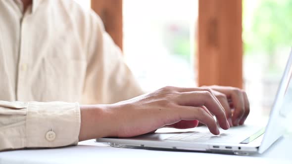 4K Footage Close-up of the hand that is operating the laptop keyboard. alt