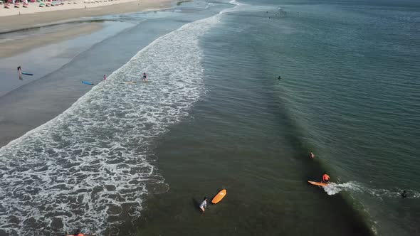 Surfers Ride in the Sea
