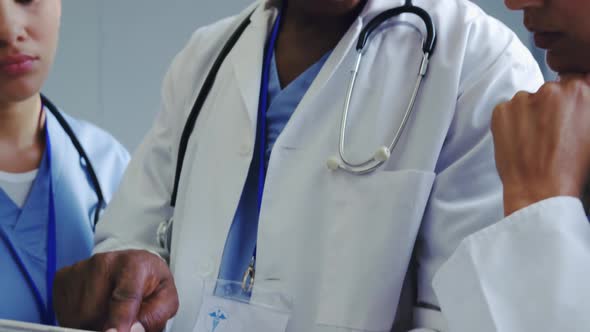 Close-up of Multi-Ethnic doctors discussing over medical report in hospital alt