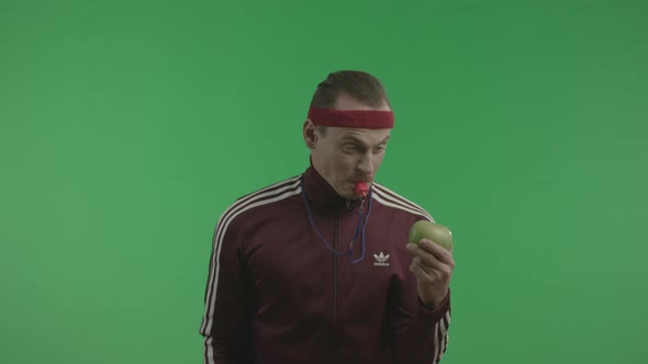 Athletic Man Is Smashing Apple By Whistle. alt