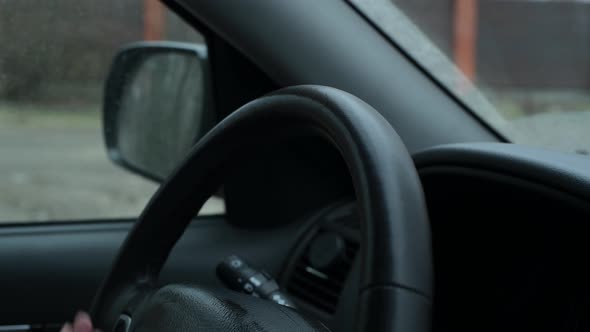 girl wipes a car steering wheel with an antibacterial wipe during a pandemic alt