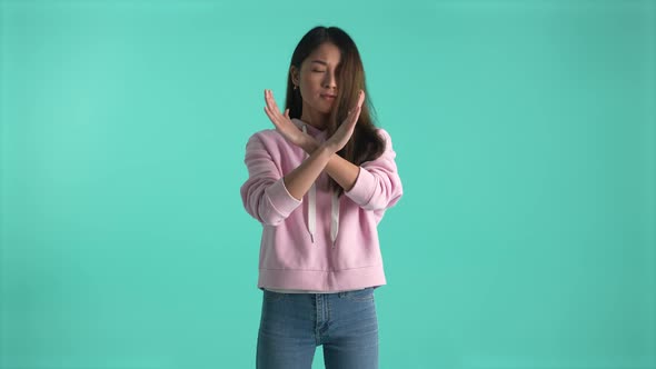 Cute Asian Girl Crossing Arms in X Sign Saying No alt