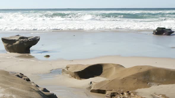 Big Ocean Wave Crashing on Beach California Coast Eroded Stone or Rock on Sand