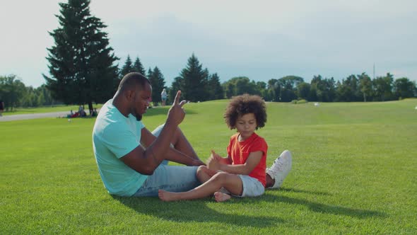 Dad with Little Son Playing Leisure Games Outdoors alt