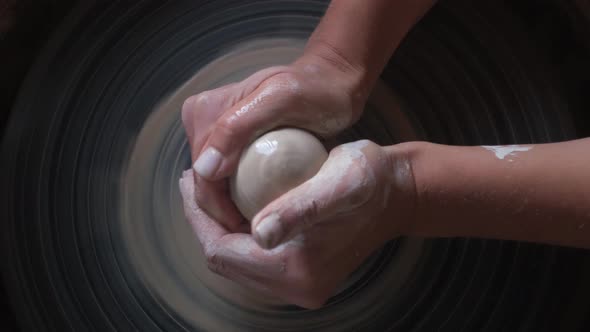 Ceramist Start  Working Modern Handmade Ceramics. Potter put a Piece of White Clay on Wheel