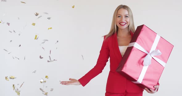 Gorgeous Woman in Red Suit with Christmas Gift