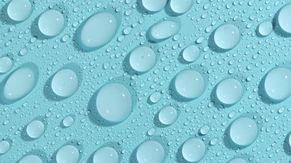 Macro Shot of Cosmetic Moisturizing Drops of Liquid on a Greenblue Pastel Background alt